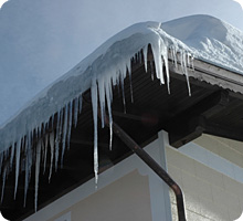 Eiszapfen quellen aus der Dachrinne